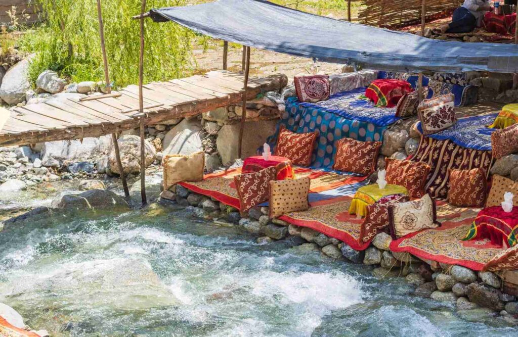 Scenic view of the Ourika Valley with waterfalls and lush greenery, a highlight of the Ourika Valley Day Trip.